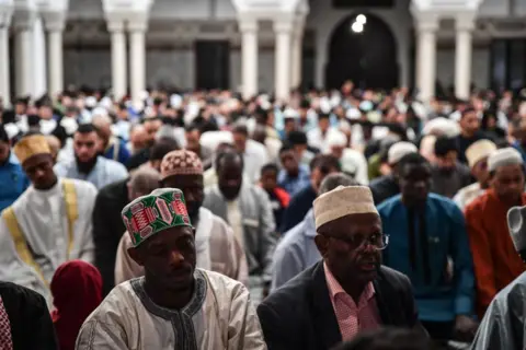 Firas Abdullah/Getty Images Muslims perform the Eid al-Adha prayer at the Grand Mosque of Paris, France