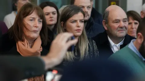 PA/Brian Lawless The parents of murdered teacher Ashling Murphy, Kathleen (left) and Raymond (right) and her sister Amy (centre),