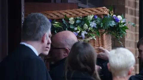 PA Media Pall bearers carry the casket into the Requiem Mass for former Rochdale MP and Greater Manchester mayor Tony Lloyd, at St Hugh Of Lincoln RC Church in Stretford, Manchester, following his death on January 17