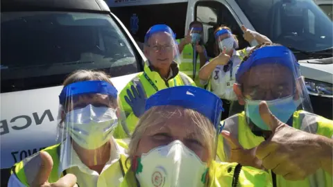 Ezec Patient Transport  Health workers with visors