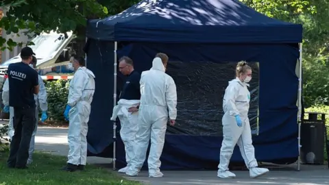 Getty Images Forensic experts secure evidence at the site of a crime scene in Berlin