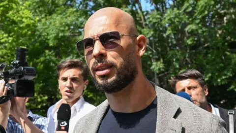 Getty Images Andrew Tate arrives at the Bucharest Court building, June 2023