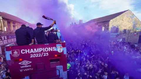 PA Media Purple smoke by the Burnley bus