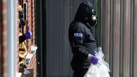 Getty Images A police investigator in a protective suit in Amesbury