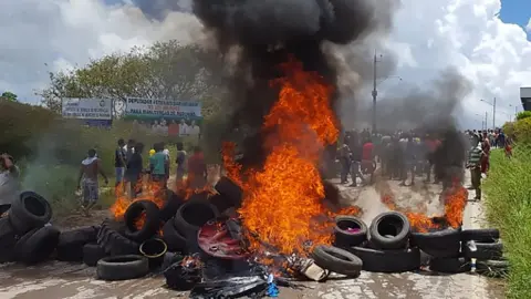 AFP Residents of Pacaraima burn tyres and belongings of Venezuelans immigrants after attacking their makeshift camp on August 18, 2018