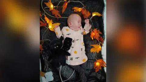 Daniel Chambers Robyn in Halloween-themed pyjamas