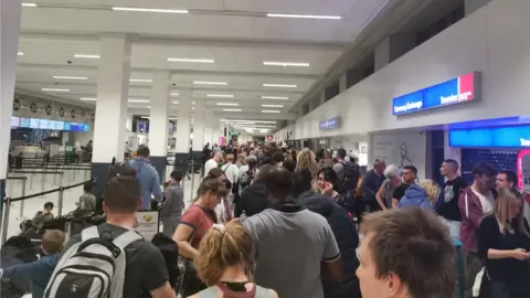 Daniel Shortall Queues at the easyJet desk at Manchester Airport