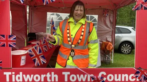 BBC A woman wearing high vis in a Tidworth Town Council tent