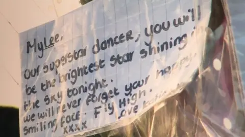 Notes and tributes left outside the bungalow where Mylee was found