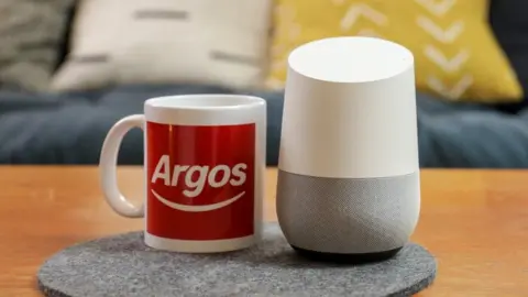 Argos Argos mug next to a smart speaker