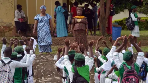 AFP Teachers of Tundunwada Secondary School speak to students about Ebola during an assembly in Abuja on September 22, 2014.