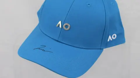 Love All A signed cap donated by Naomi Osaka