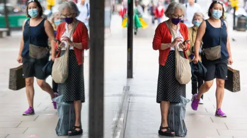 PA Media Shoppers on Oxford St wearing face masks