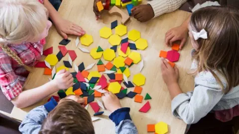 Getty Images Children play with coloured shapes