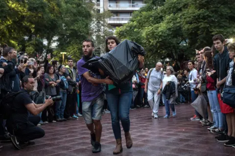 Getty Images Ballot boxes are delivered to a Barcelona polling station on 1 October 2017