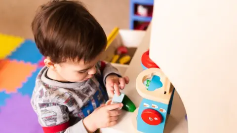 Getty Images A toddler playing at a nursery school