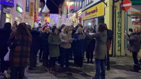 Carollers leading the parade