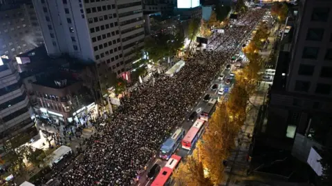 Getty Images Thousands of people took part in a candlelight vigil to mourn the 156 people killed in the October 29 Halloween crowd crush, at Seoul City Hall Plaza, in Seoul on November 5, 202