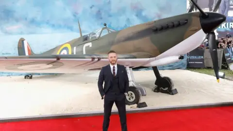 Getty Images Tom Hardy with a spitfire