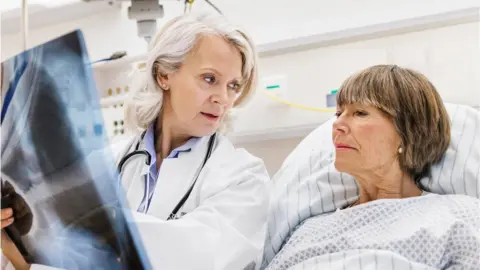TommL/Getty Images Doctor and patient