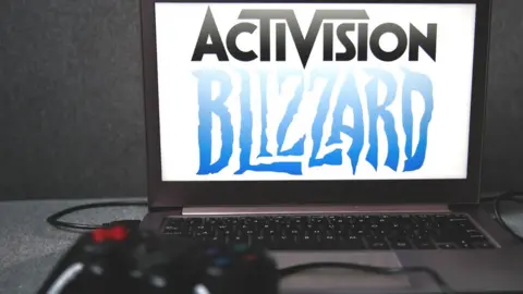 Getty Images The Activision Blizzard logo on a screen with a gamepad plugged in