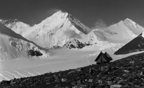 RGS-IBG/Salto-Ulbeek A snowy mountain shot including a small old-fashioned tent, captioned, "Camp at 20,000 feet - the last day"