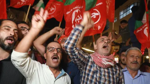 Getty Images Palestinian men in crowd in Gaza City