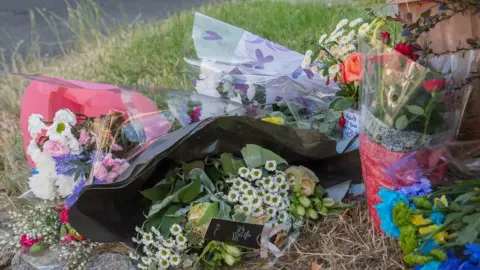SWNS Floral tributes left at the scene