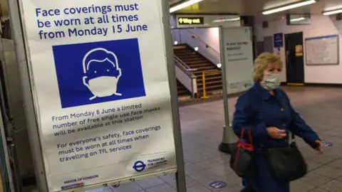 Getty Images Face covering board in London Underground