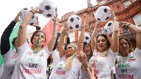 James Manning/PA Wire Iranian women protesting World Cup