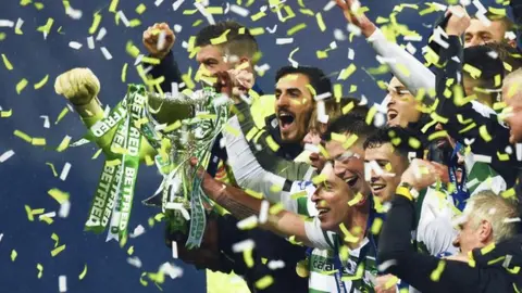 Celtic players celebrate winning the League Cup