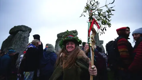 Ben Birchall/PA Woman celebrating the winter solstice at Stonehenge