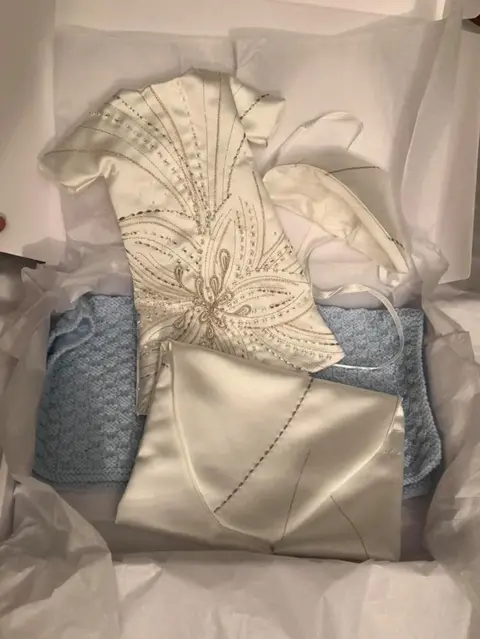 Zaagi The gown sets come with a keepsake pouch for the parents