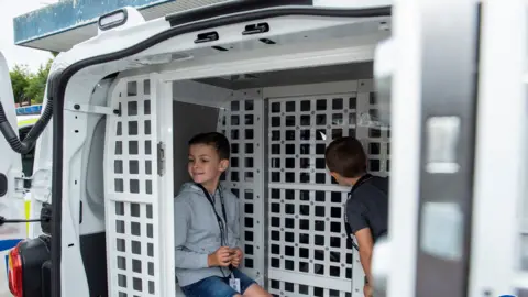 West Midlands Police Oscar and Charlie in a police van