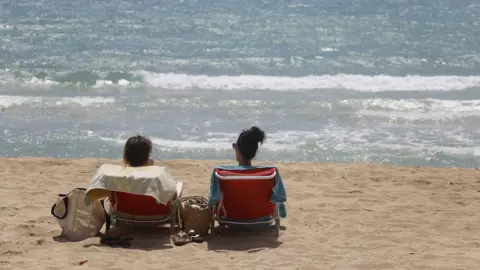 Getty Images People sunbathe in Arenal beach on June 16, 2020 in Palma de Mallorca (June 2020)