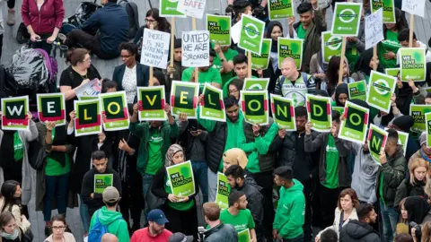 Getty Images People hold up signs which spell out "We Love London" as hundreds gather for a vigil in Potters Fields