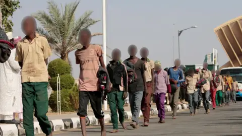 Freed Nigerian schoolboys walk after they were rescued by security forces in Katsina, Nigeria, December 18, 2020. REUTERS/Afolabi Sotunde