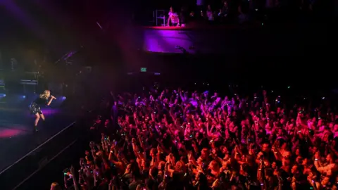 Getty Images Taylor Swift singing at a concert