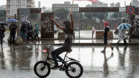 Getty Images Protester waving the Lebanese flag in central Beirut