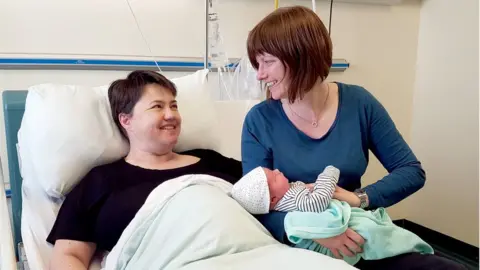 PA Media Ruth Davidson pictured after the birth of her son, Finn, with her partner, Jen Wilson