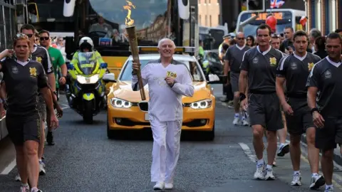 Ben Birchall/PA Stan Wild with Olympic torch in 2012