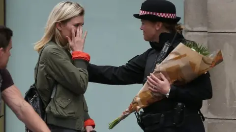 AFP A woman laying flowers