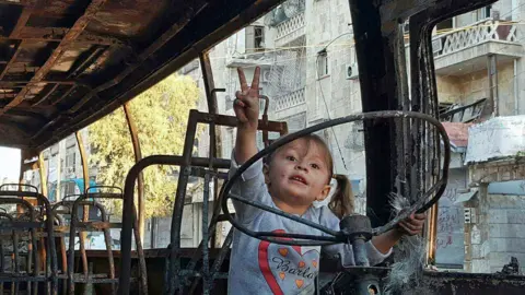 Salim Mudar Girl on burnt-out bus