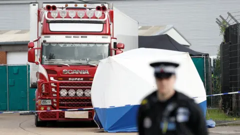 Reuters Police officer and forensic tent near lorry