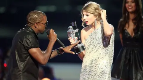 CHRISTOPHER POLK/GETTY Kanye West interrupting Taylor Swift at the 2009 MTV VMA's