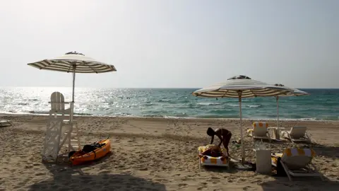 Getty Images Foreign tourists enjoying the beach in Abu Dhabi