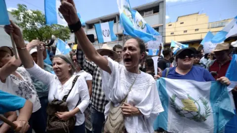 Reuters Demonstrators protest against Guatemalan President Jimmy Morales outside Guatemala's Constitutional Court in Guatemala City, Guatemala, August 27, 2017