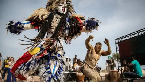 Annika Hammerschlag Performers dance along the coastal walkway on May 21, 2022 as part of the Dakar Biennale.