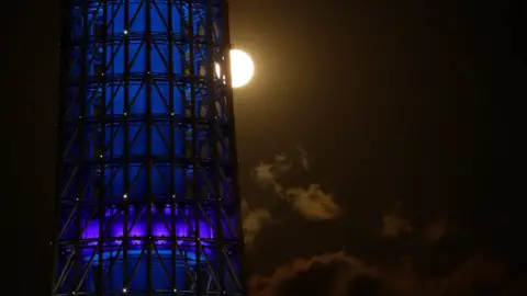 Reuters The full moon, also known as the Supermoon or Flower Moon, rises next to Tokyo Skytree in Japan