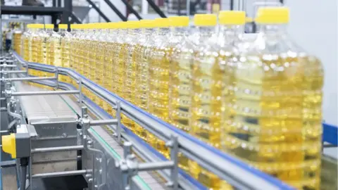 Jason Dean/Getty Images Vegetable oil is packaged in a vegetable oil factory